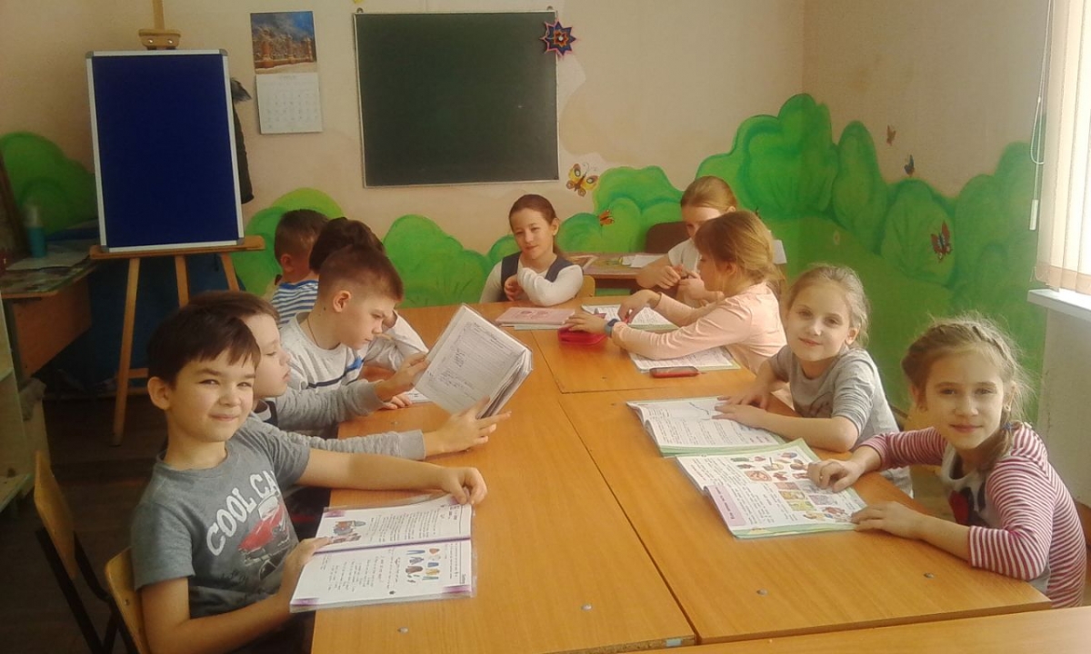Дети за столом с методическими материалами